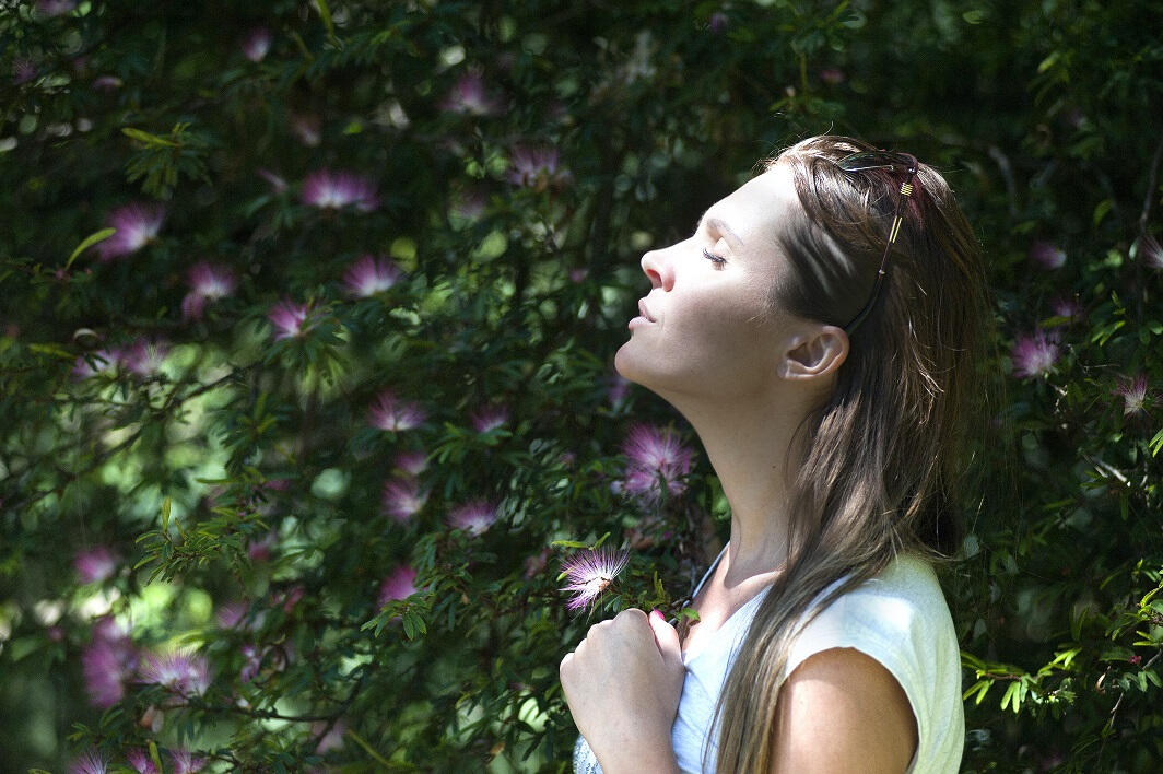 Woman holding a purple flower